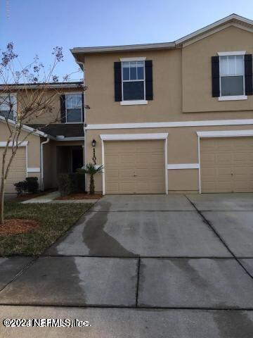 a front view of a house with parking