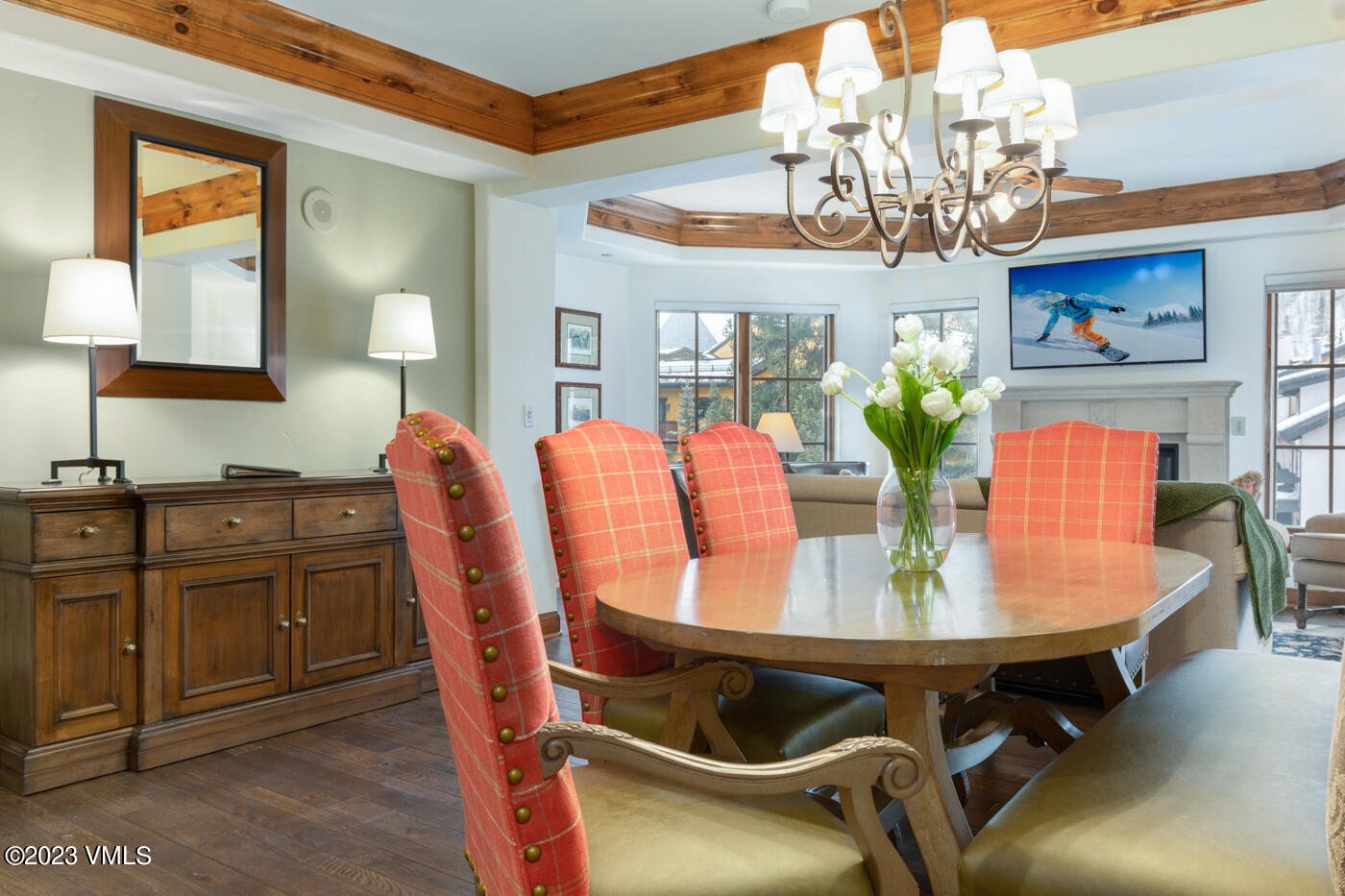 a view of a dining room with furniture a chandelier and wooden floor