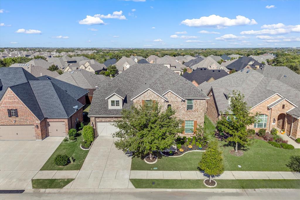 an aerial view of a house with a yard