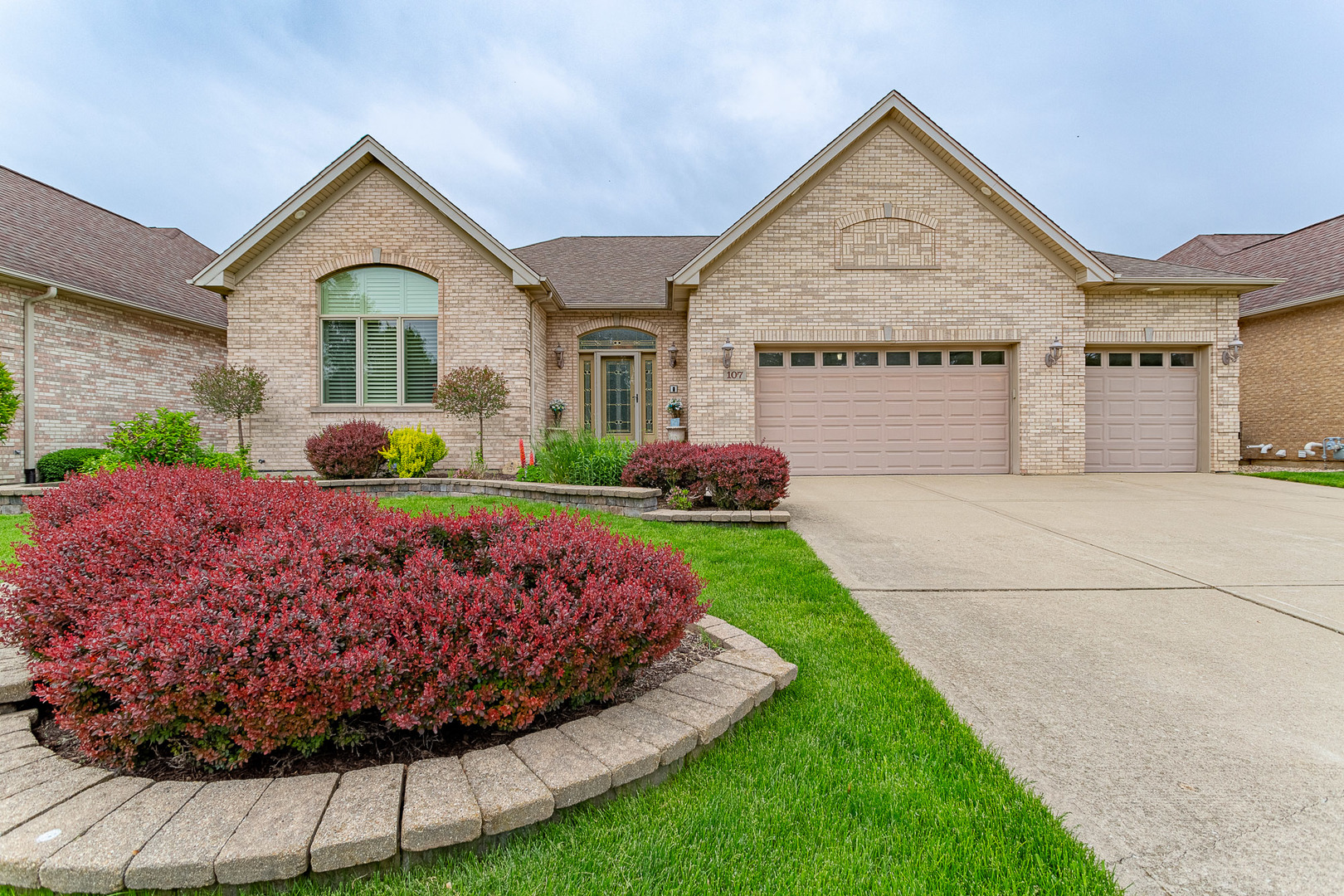 a front view of a house with a yard and garage