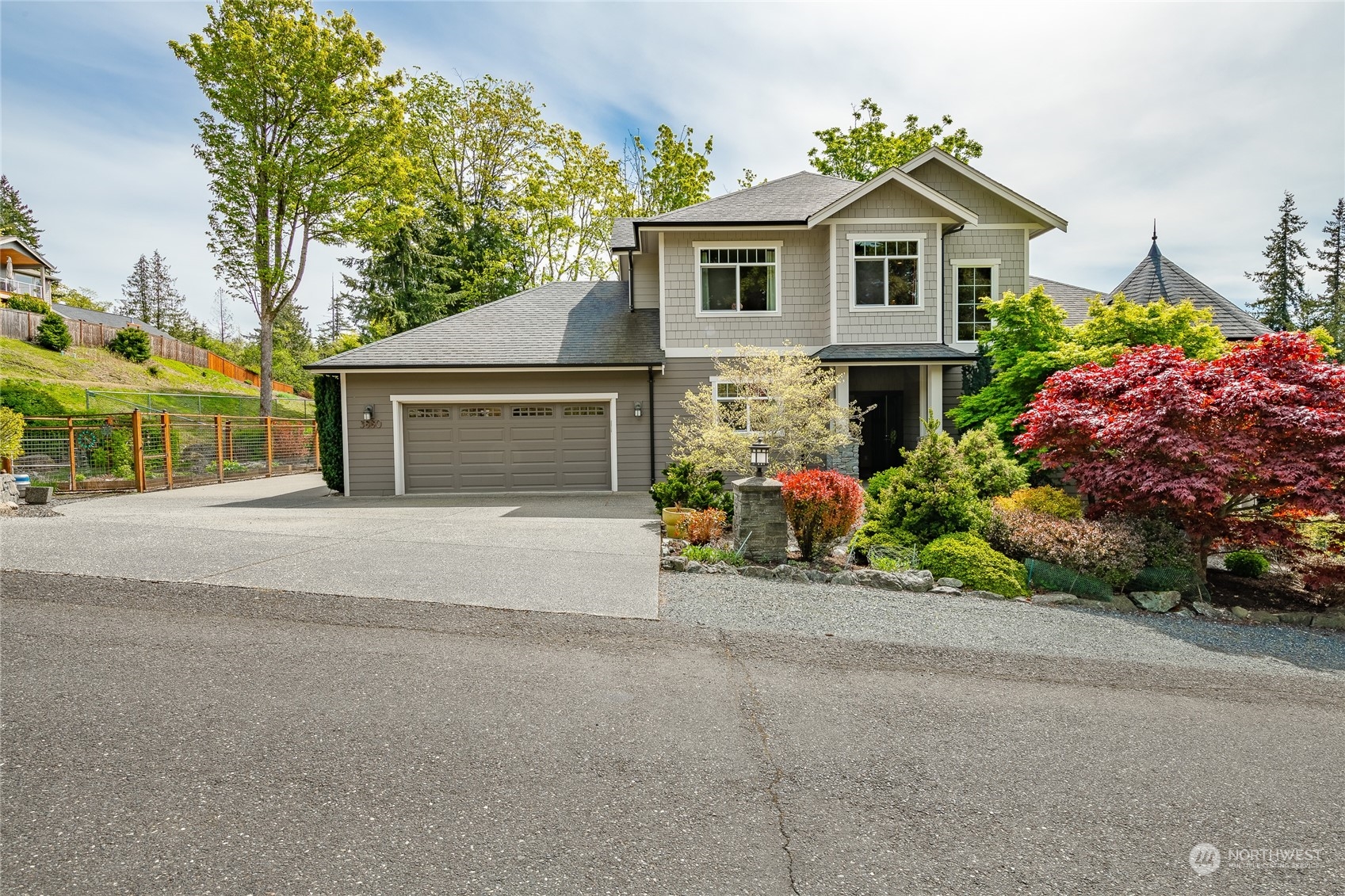 a view of a house with a yard and potted plants