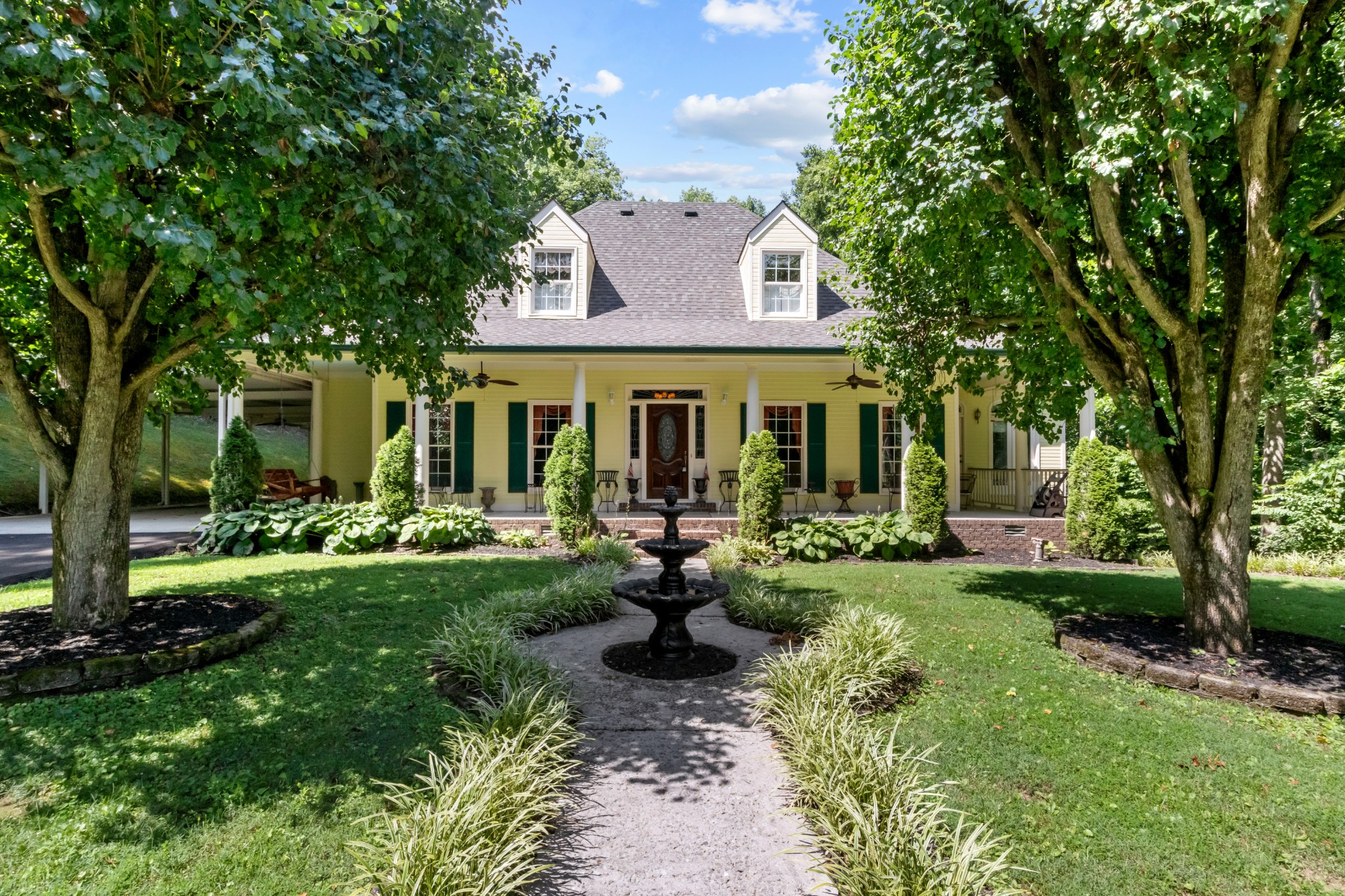 a view of a house with backyard sitting area and garden