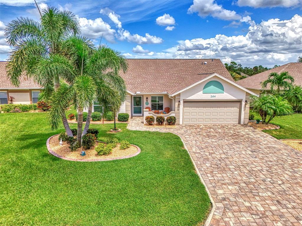 a front view of a house with a garden and patio