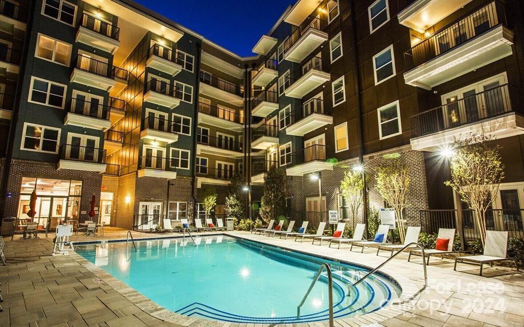 a view of a swimming pool with outdoor seating