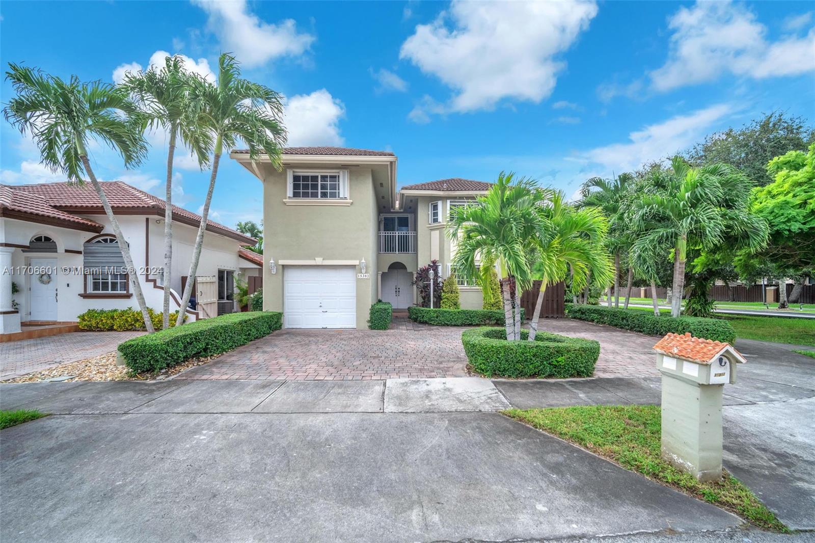 a front view of a house with a yard and a garage