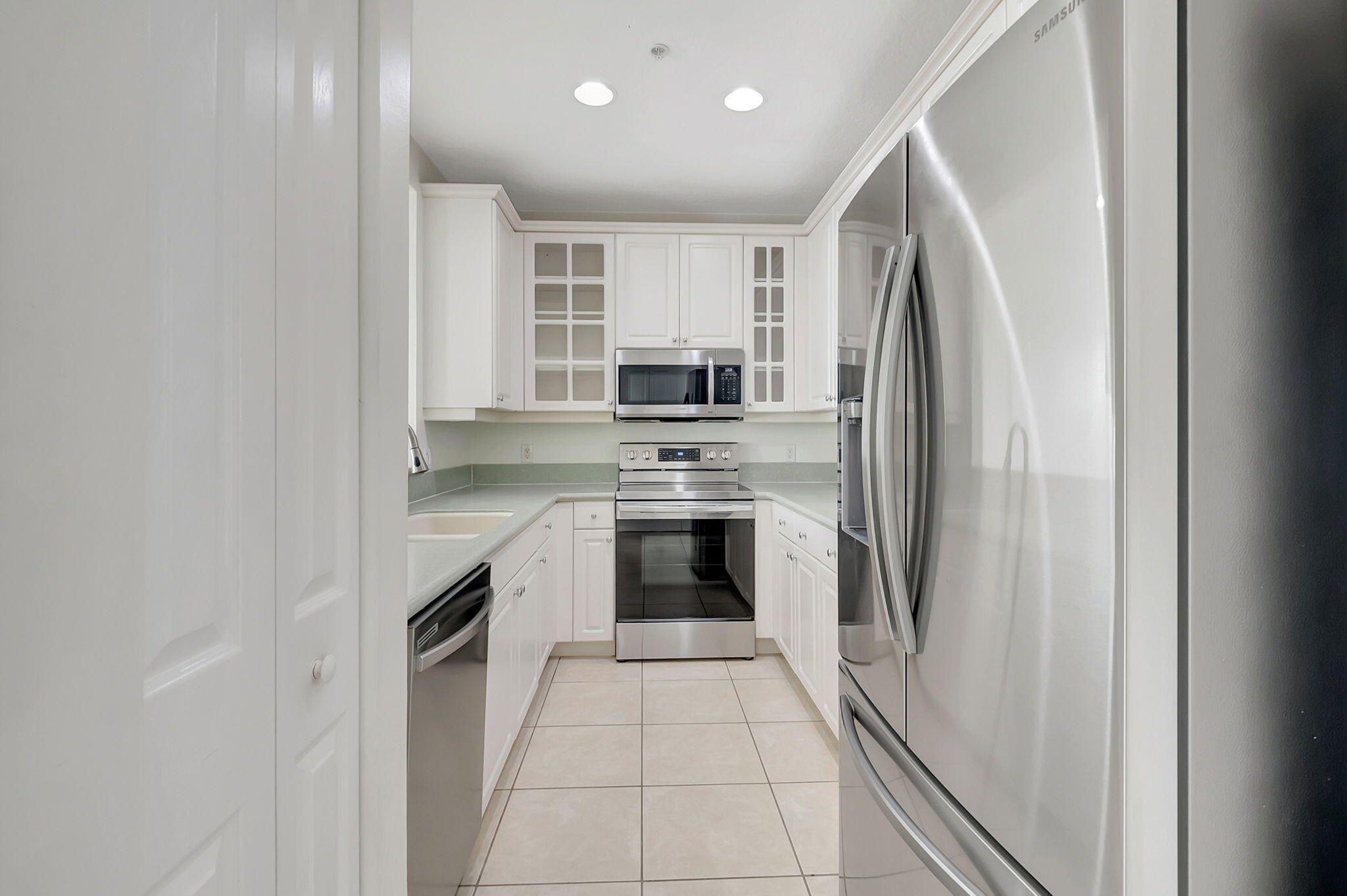 a kitchen with a stove top oven and refrigerator