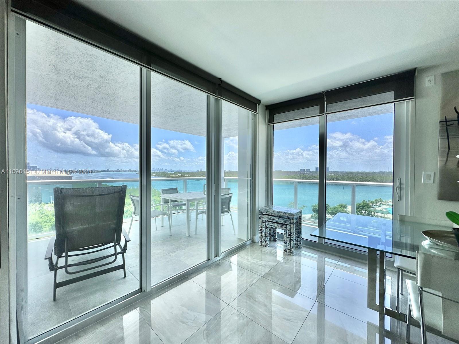 a lobby with furniture and floor to ceiling windows