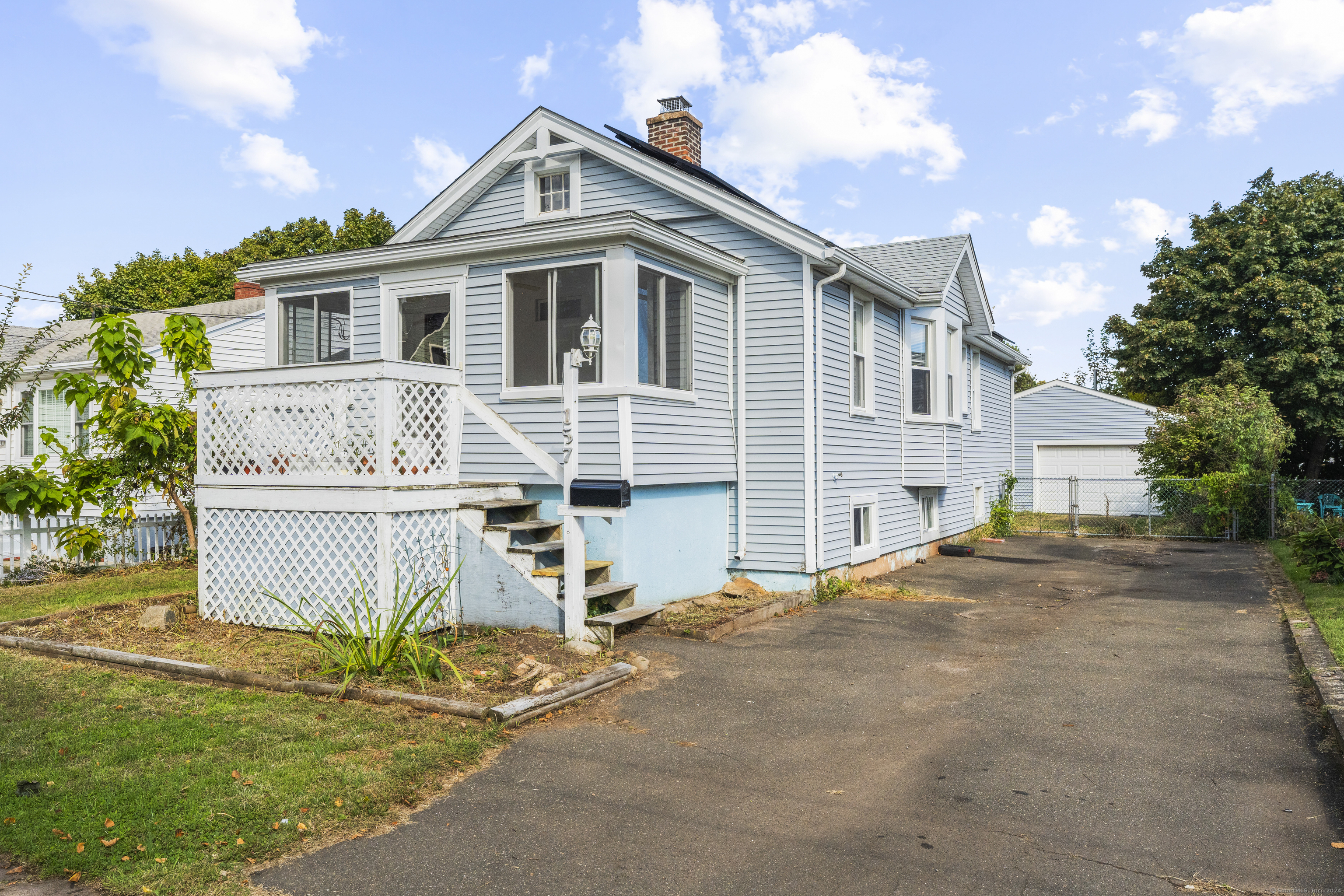 a front view of a house with a garden and garage