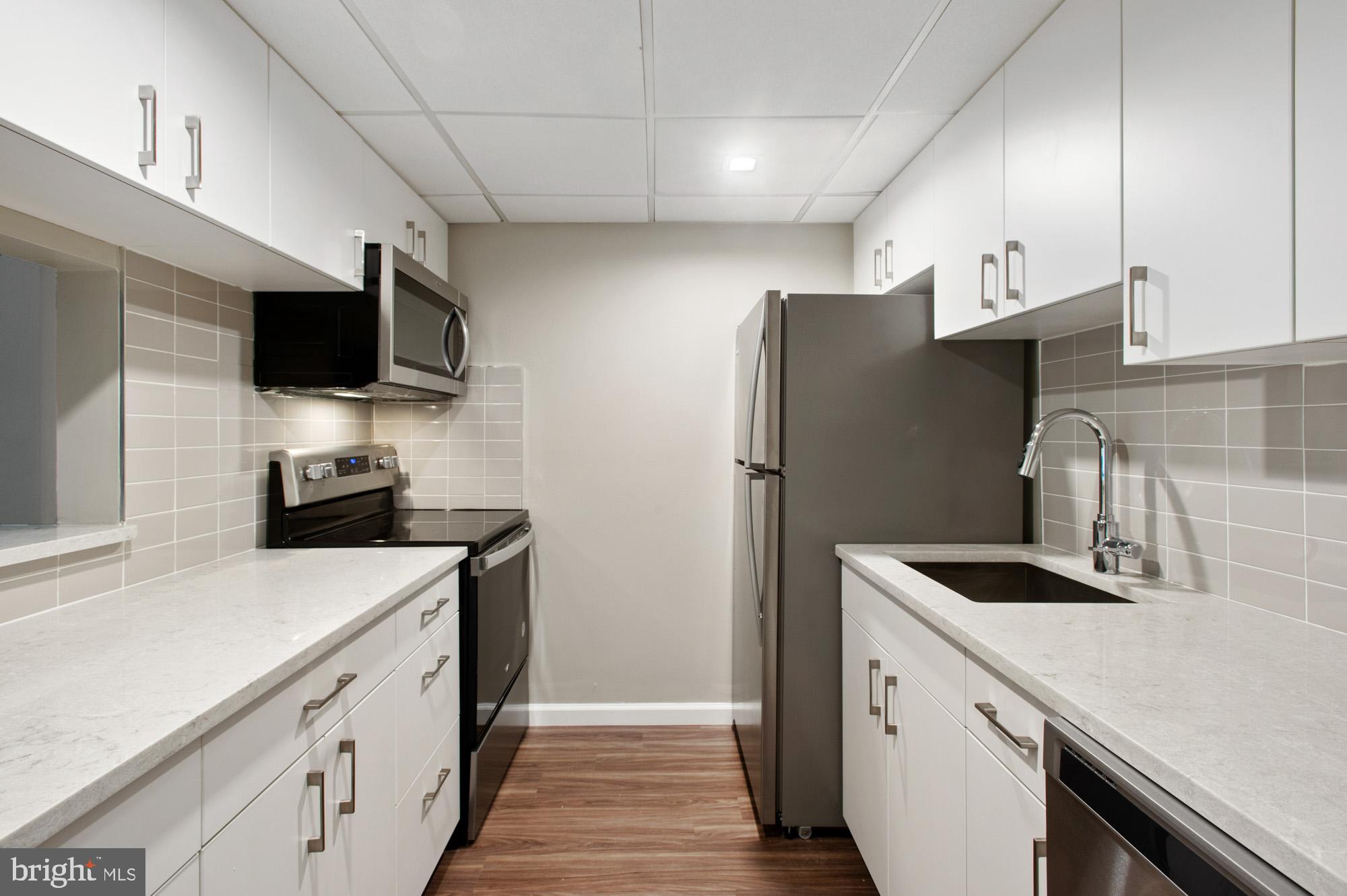 a kitchen with a refrigerator and a sink