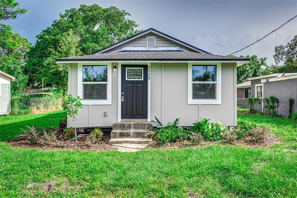 a front view of a house with garden