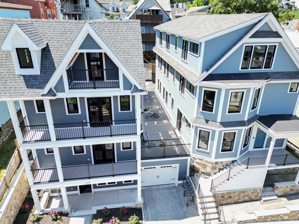 a aerial view of a brick building next to a yard