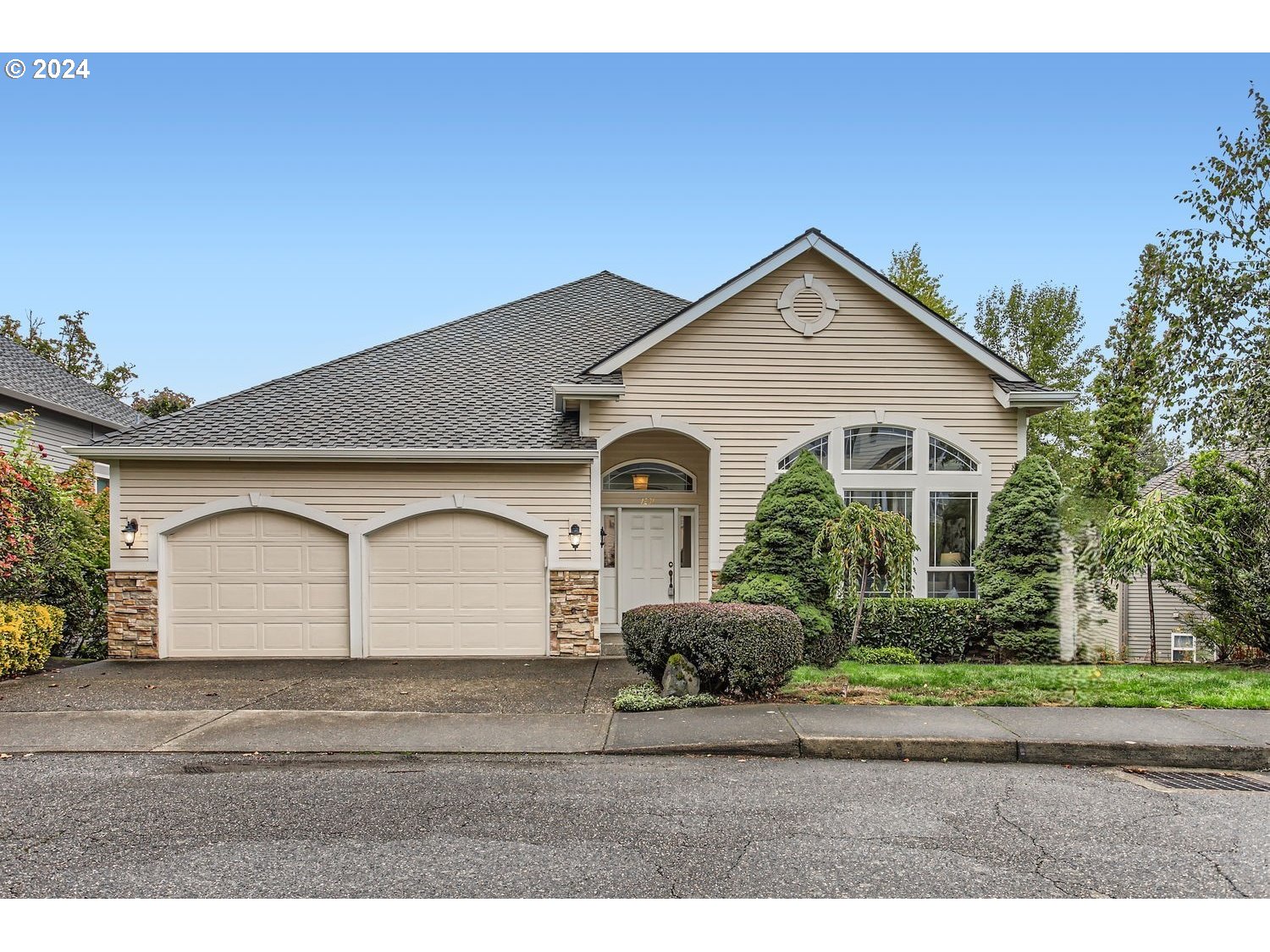 a front view of a house with a yard and garage