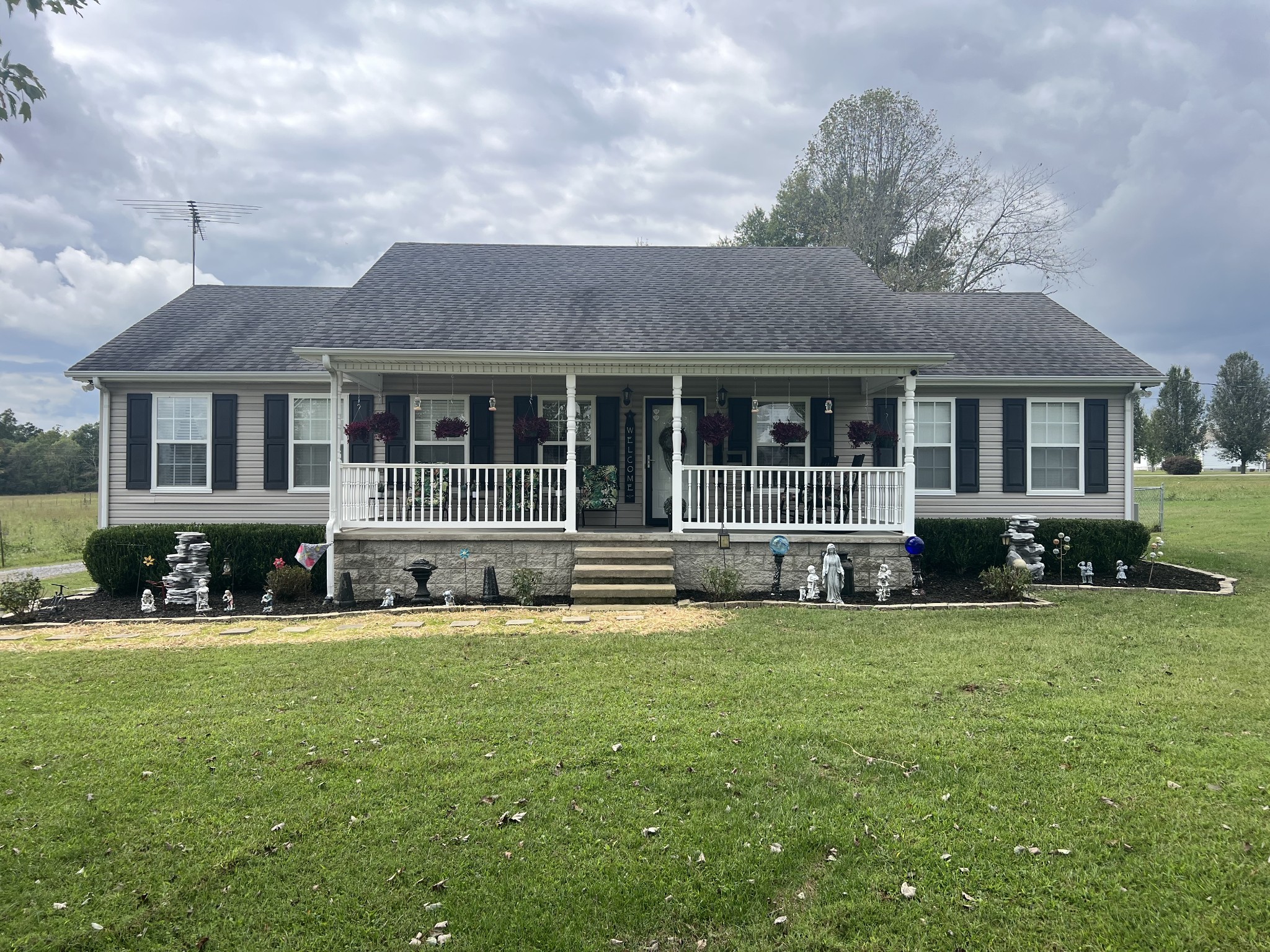 a view of house with yard and front view of a house