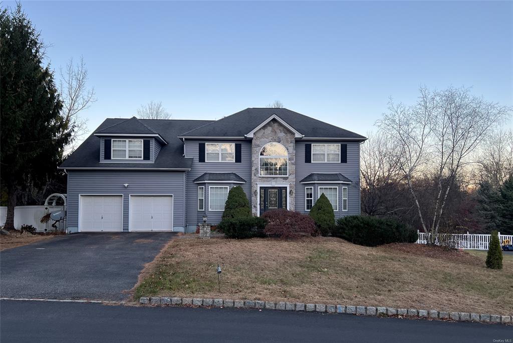 View of front property with a lawn and a garage