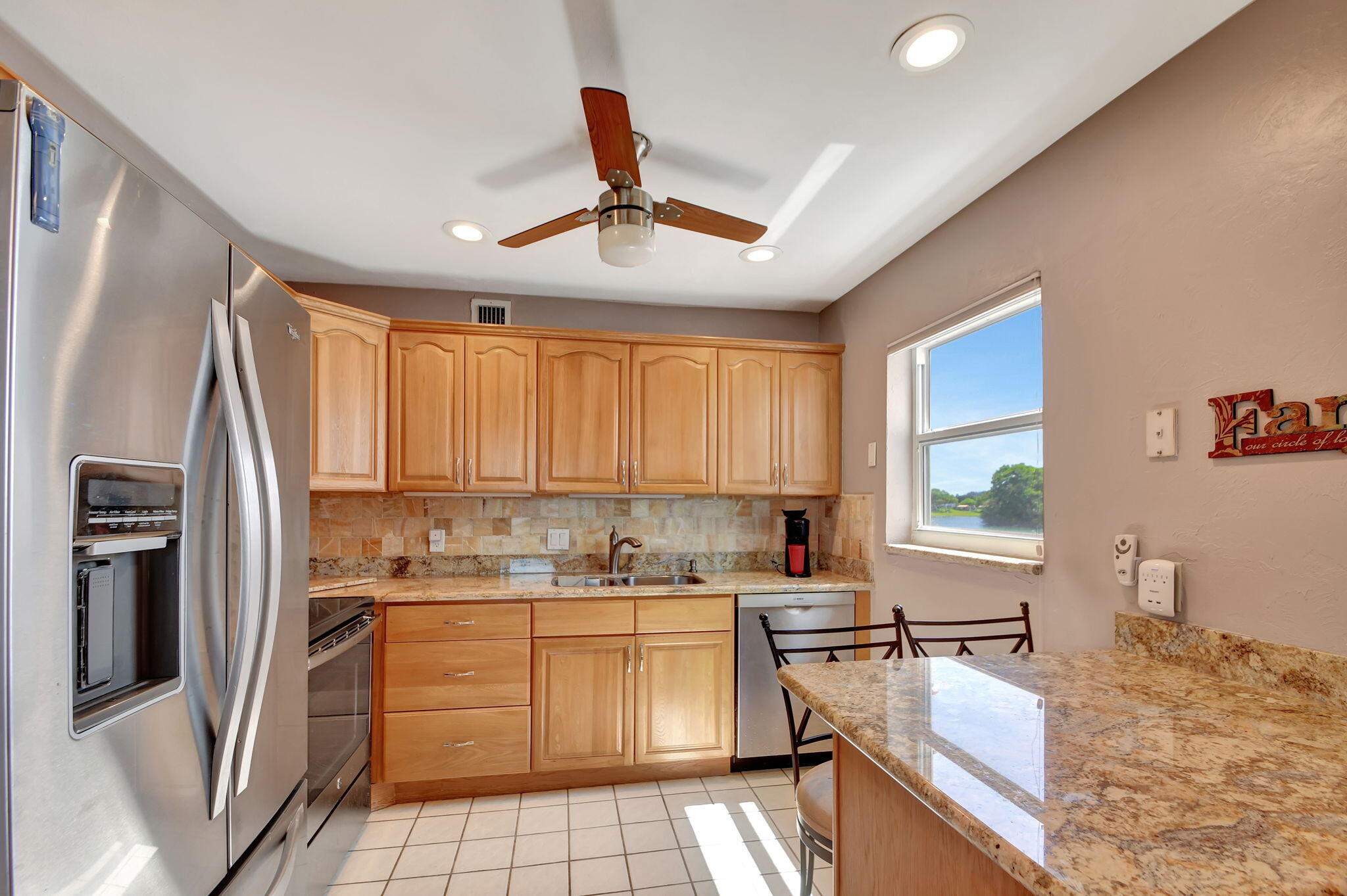 a kitchen with a refrigerator a sink dishwasher and a stove with wooden floor