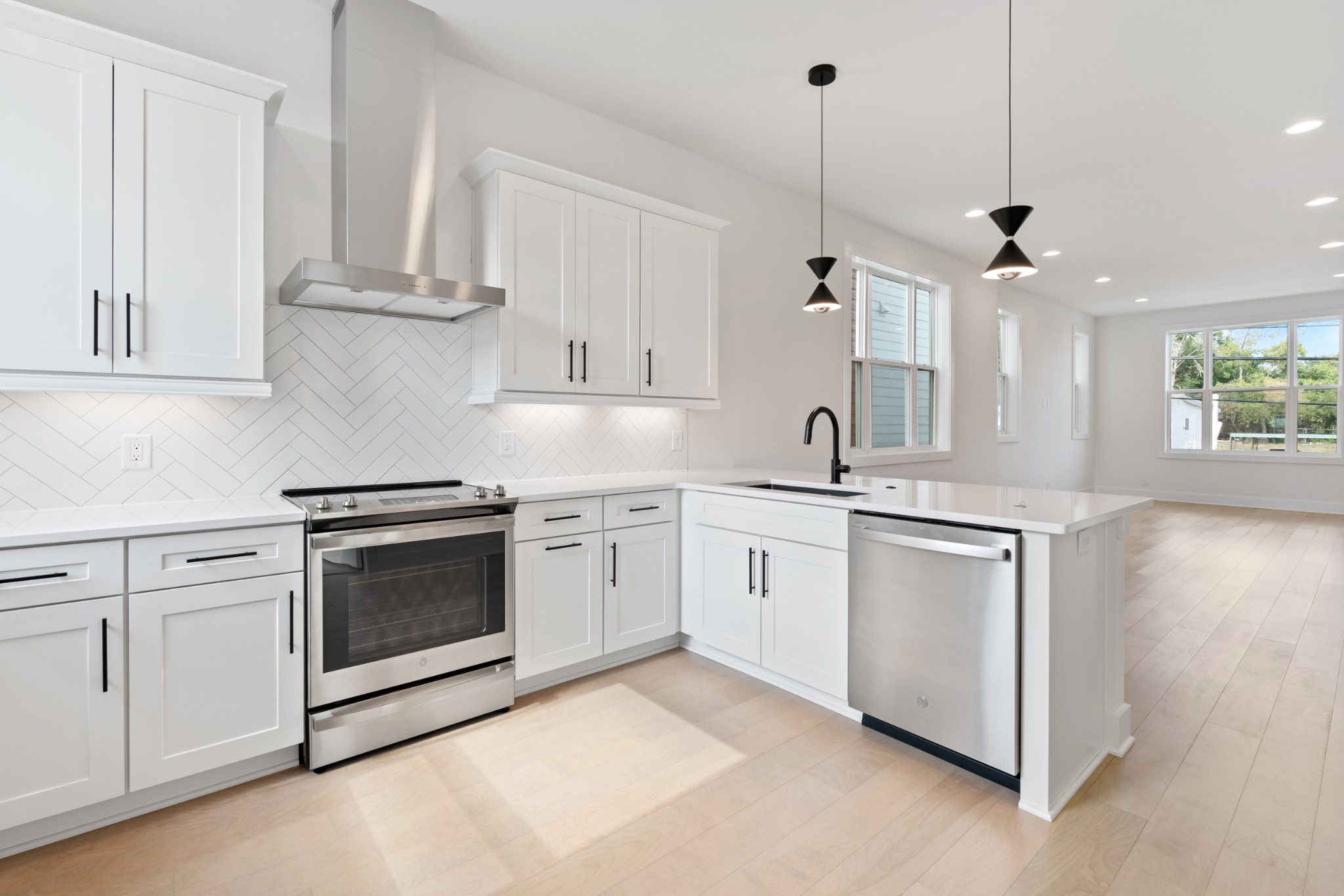 a kitchen with stainless steel appliances granite countertop a sink a stove and a granite counter tops