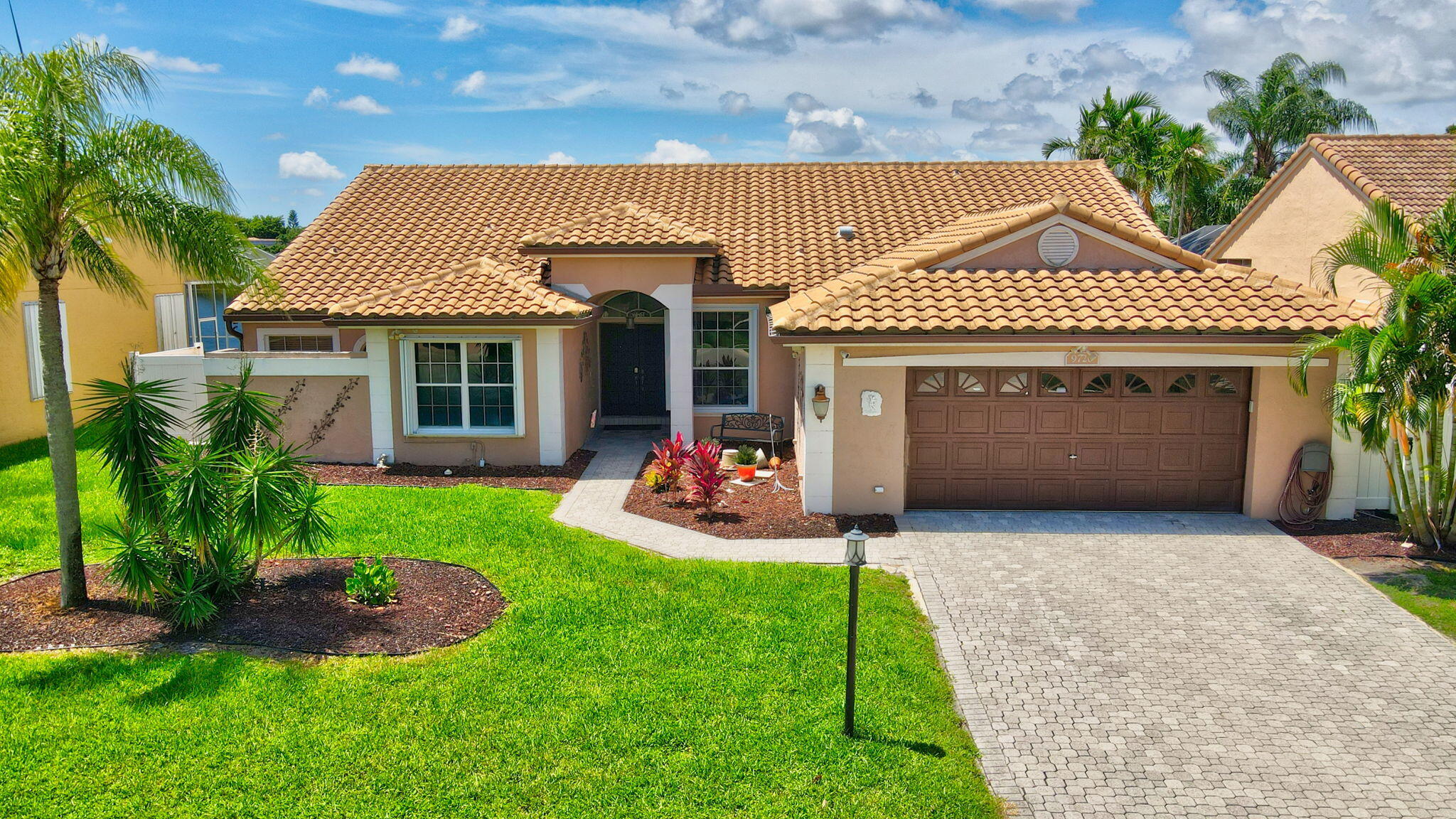 a front view of a house with a yard and porch