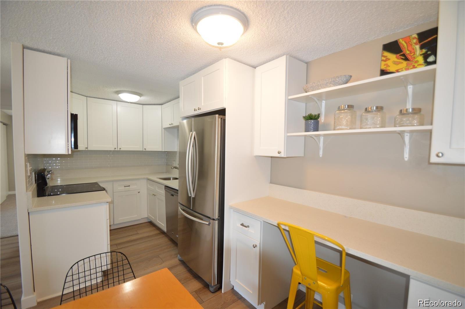 a kitchen with stainless steel appliances a refrigerator sink and microwave