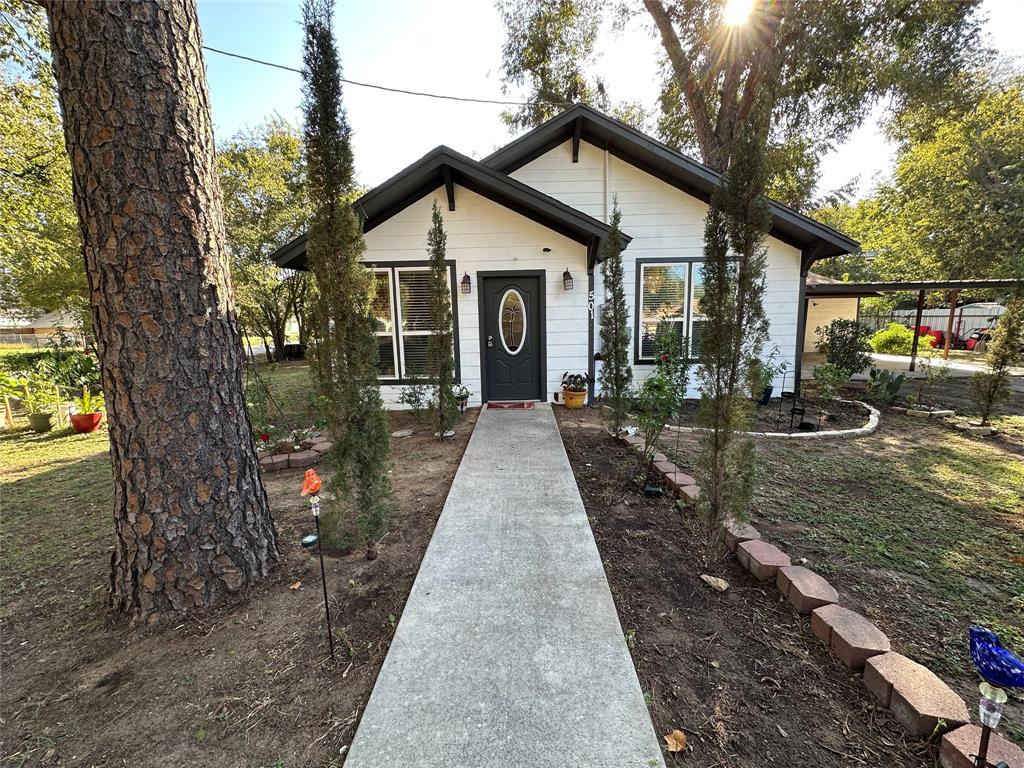 a front view of a house with garden