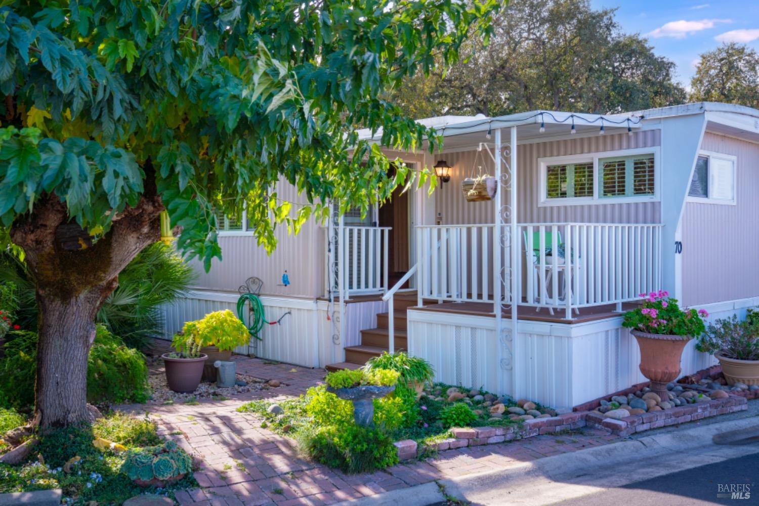 a view of a house with a yard and sitting area