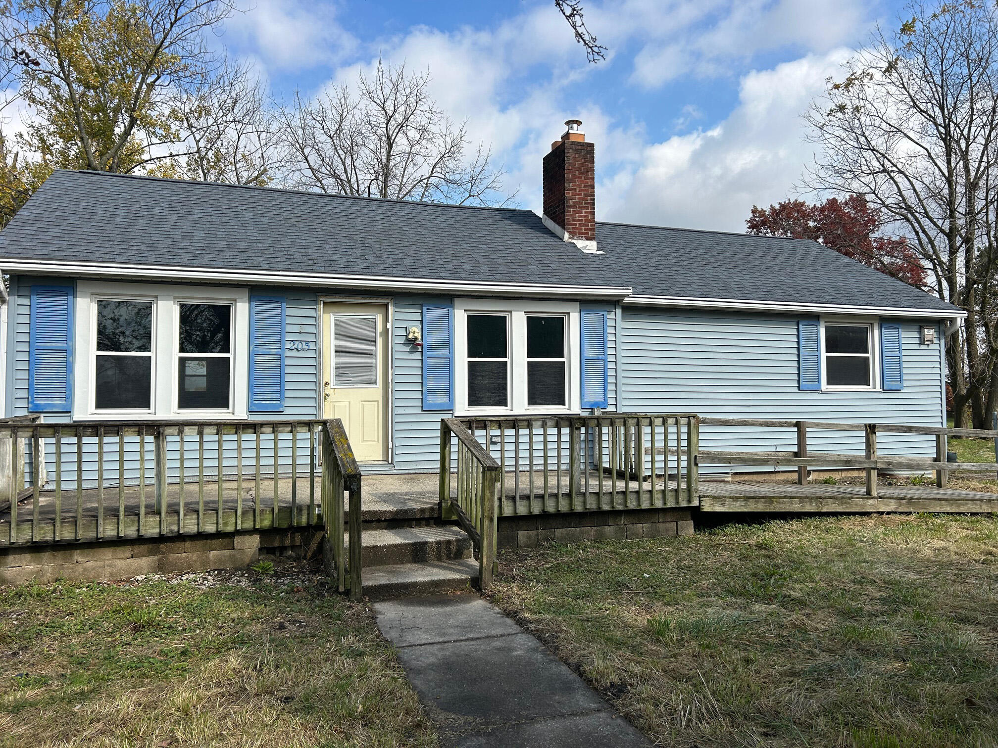 a front view of a house with a garden