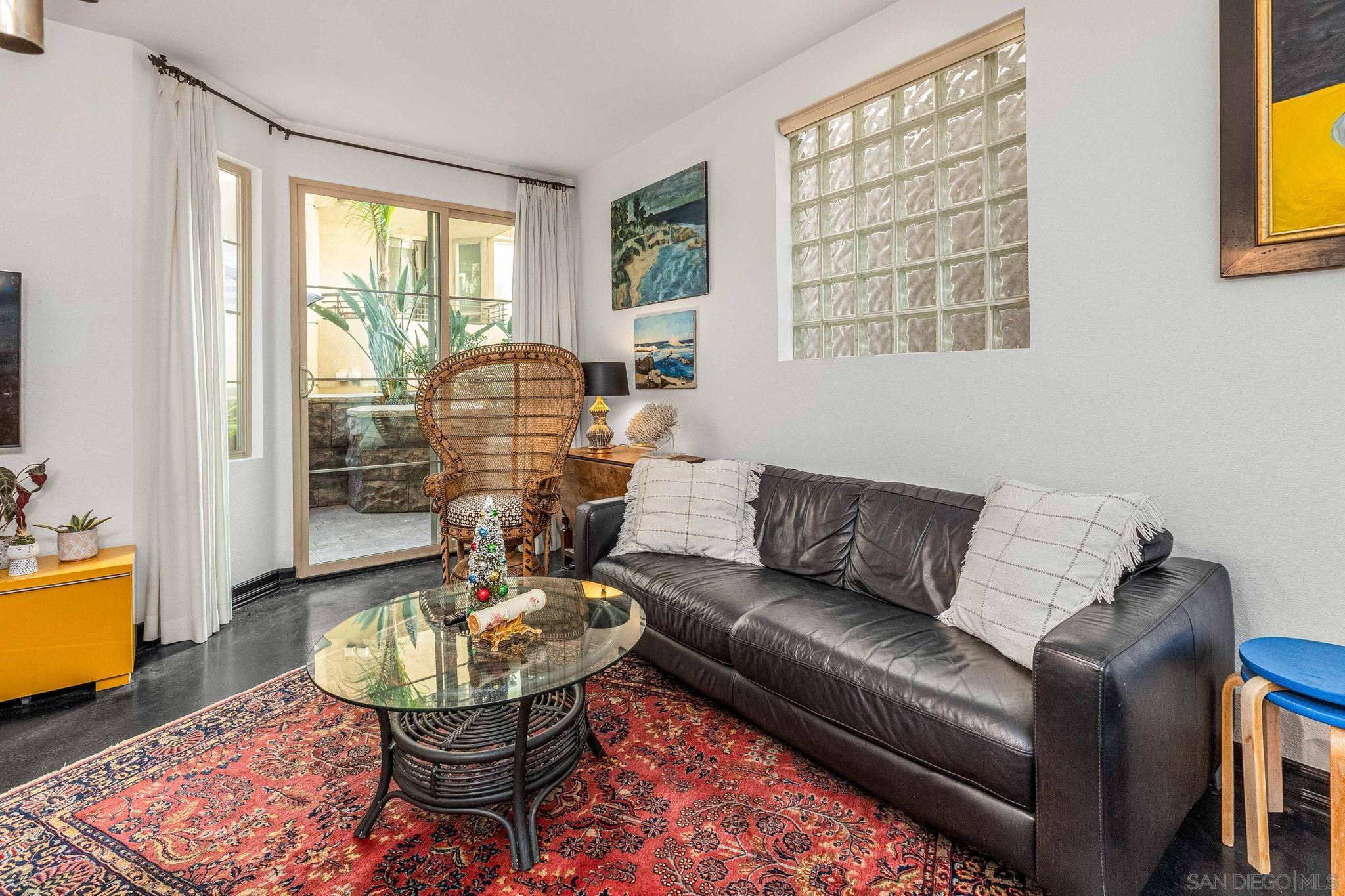 a living room with furniture and a floor to ceiling window