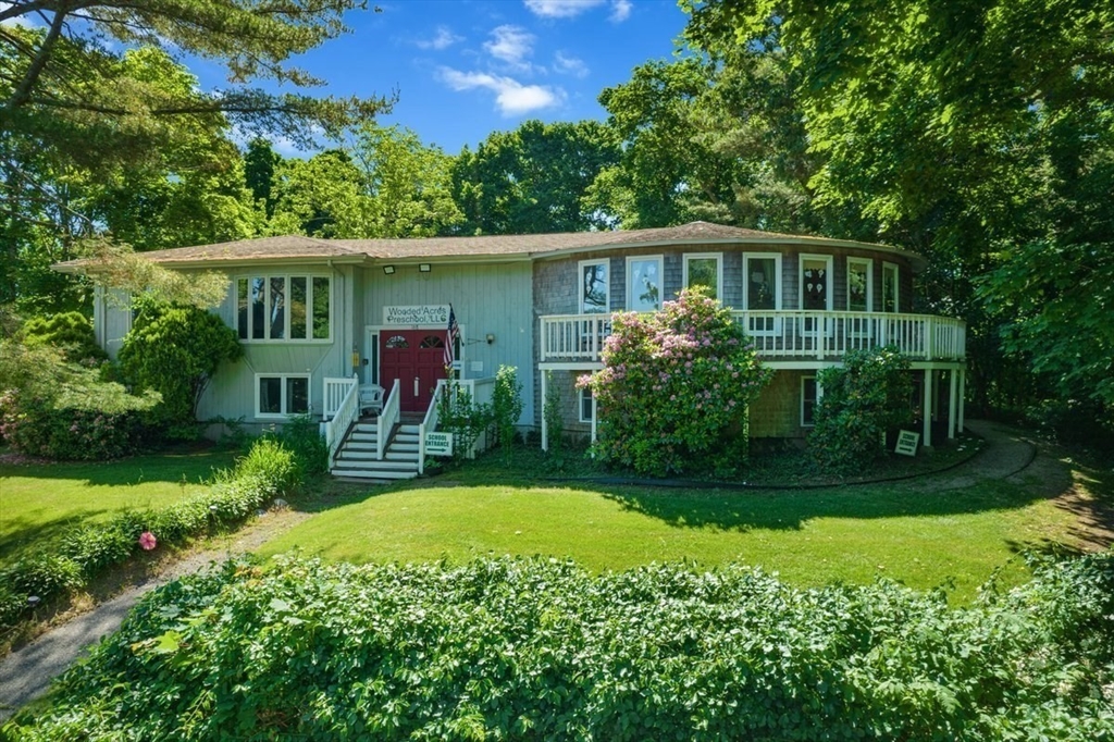 a front view of house with yard and green space