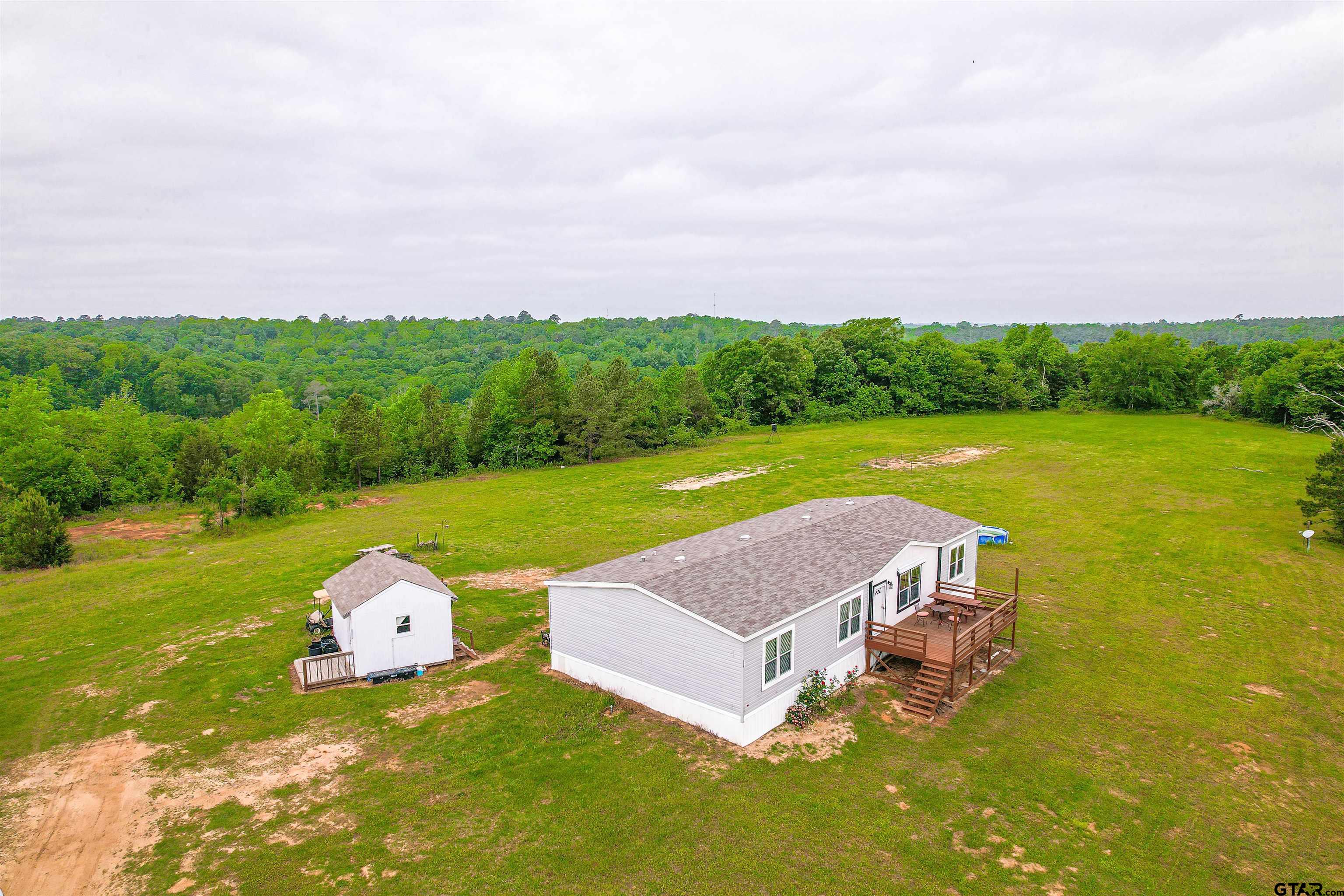 a aerial view of a house with big yard