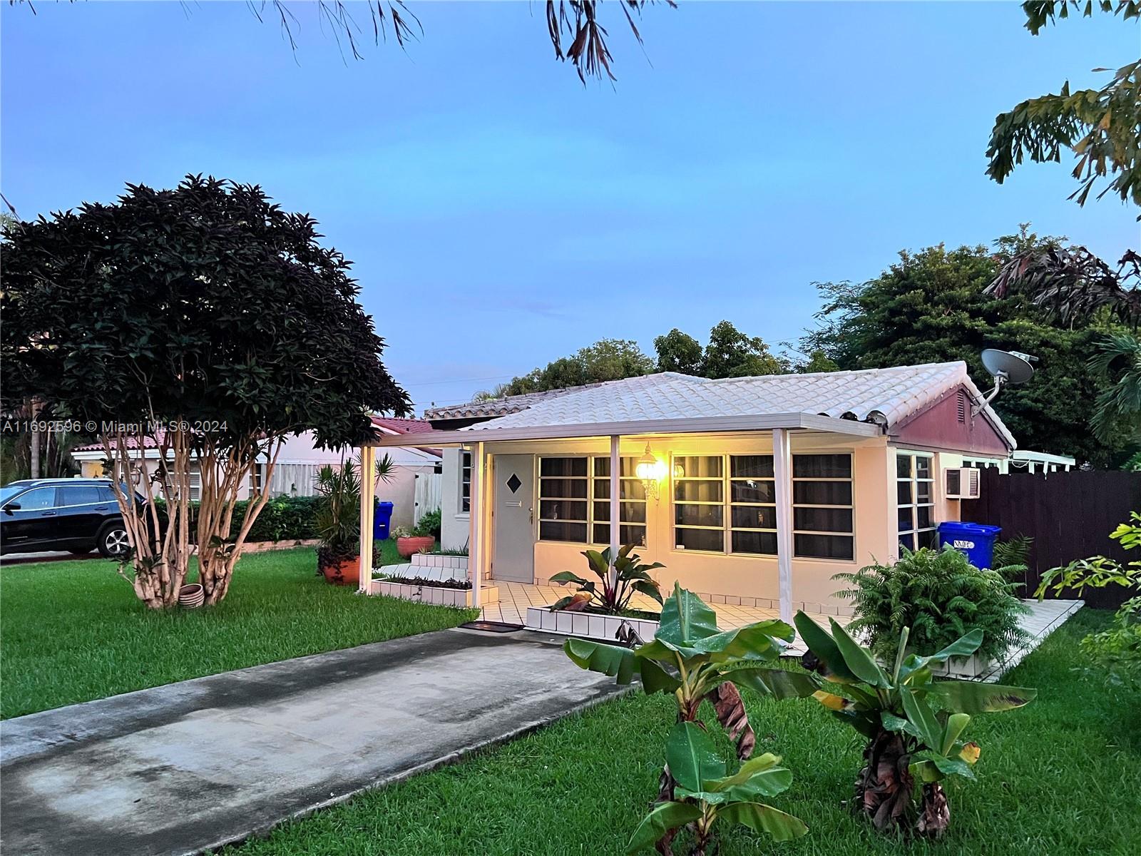 a view of a house with backyard sitting area and garden