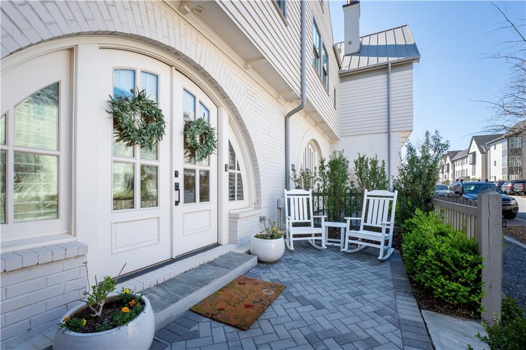 a view of a patio with couches table and chairs and potted plants