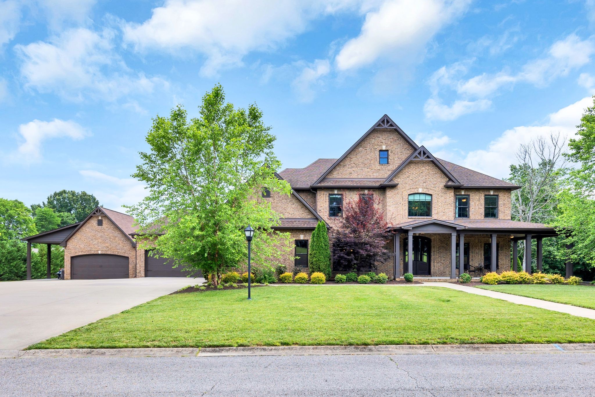 a front view of a house with a garden and plants