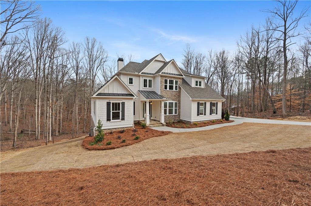 a front view of a house with a yard covered with snow