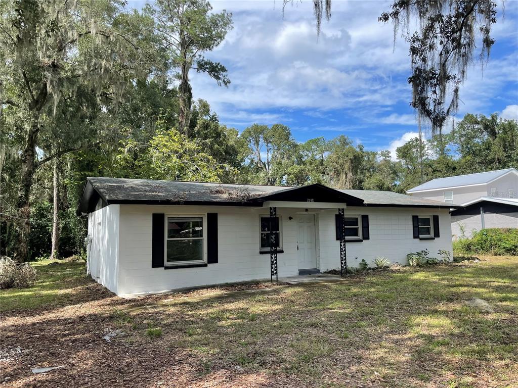 a house with trees in the background