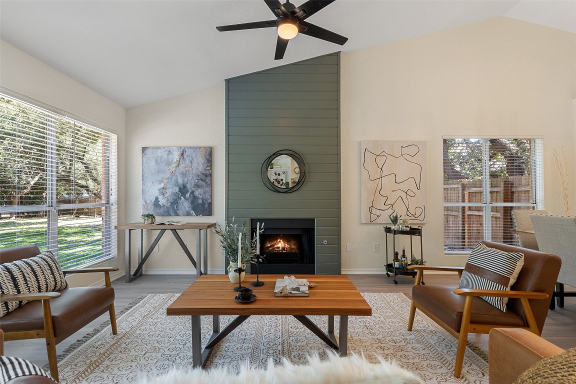 a living room with furniture a rug and a fireplace