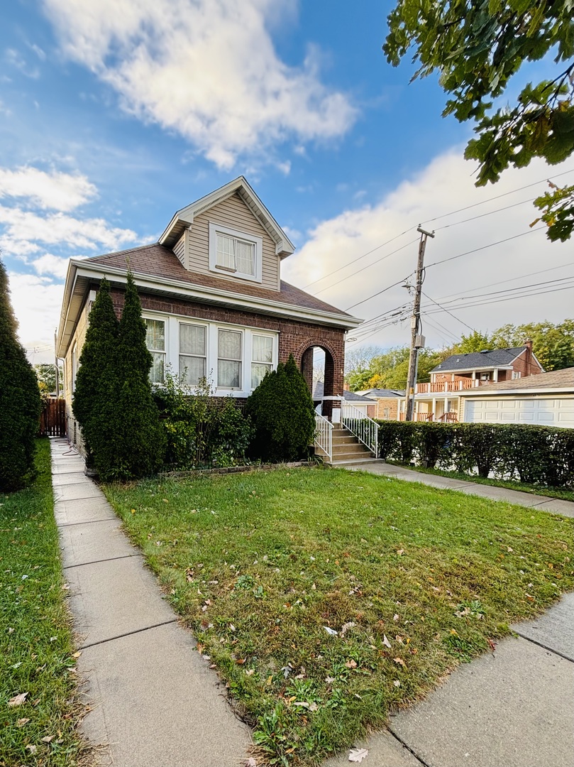 a front view of a house with a garden and plants