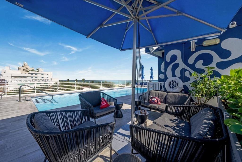 a view of a balcony with furniture and umbrella