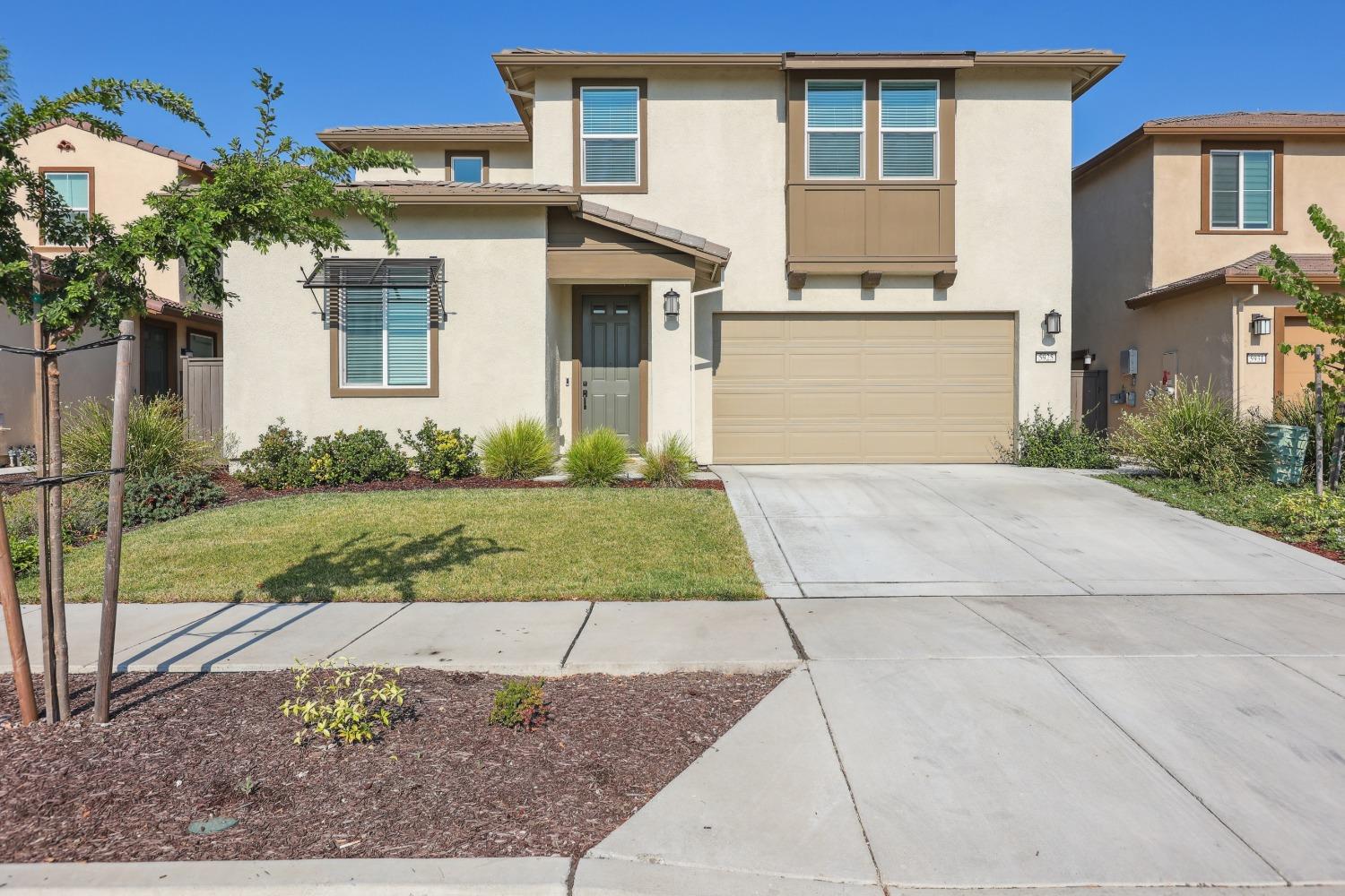 a front view of a house with garage