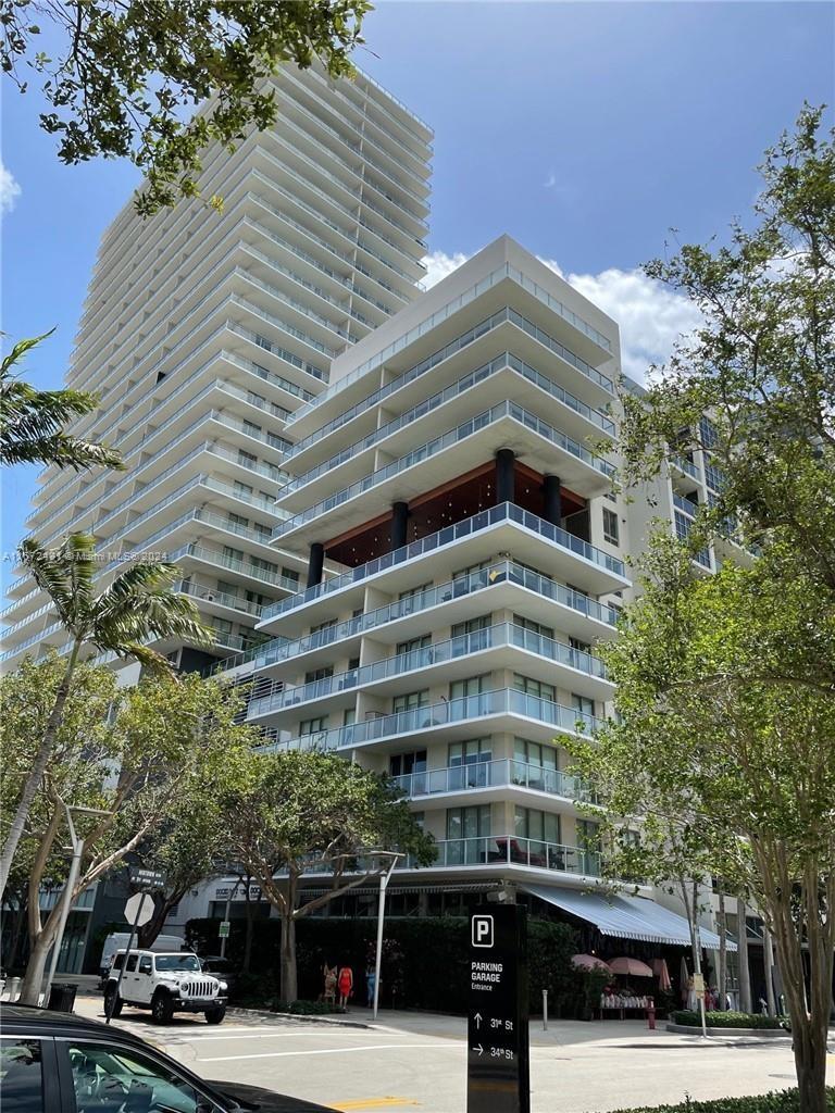 a front view of a building with trees