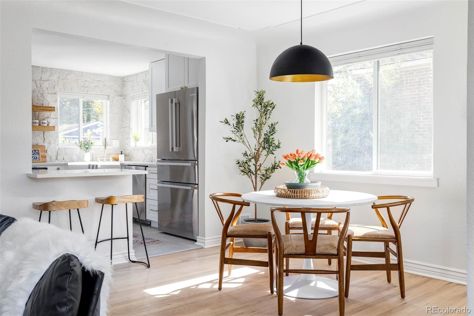 a view of a dining room with furniture window and wooden floor