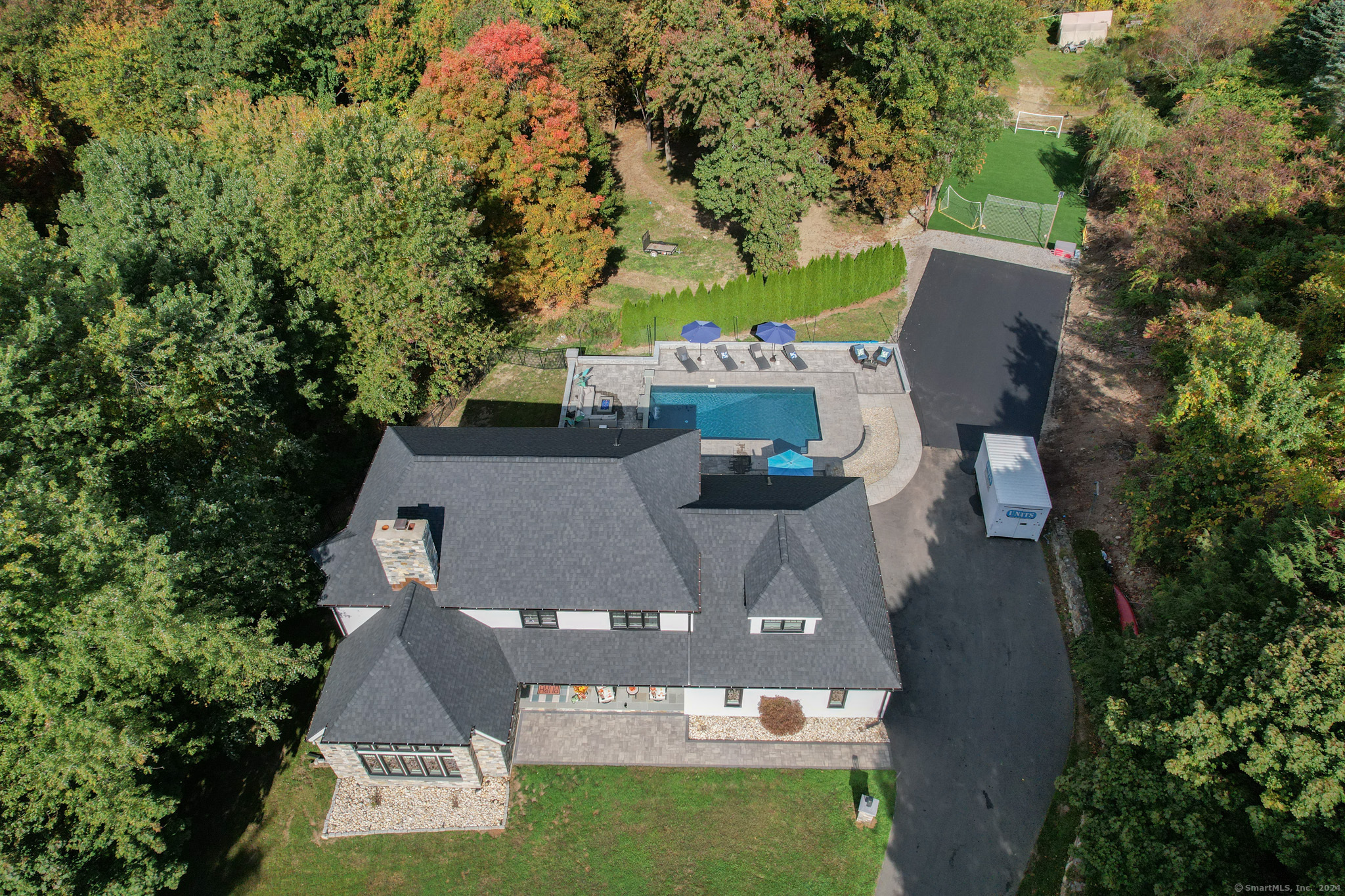 an aerial view of a house with yard swimming pool and outdoor seating