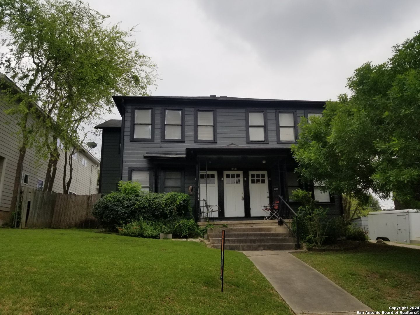 a front view of a house with a garden