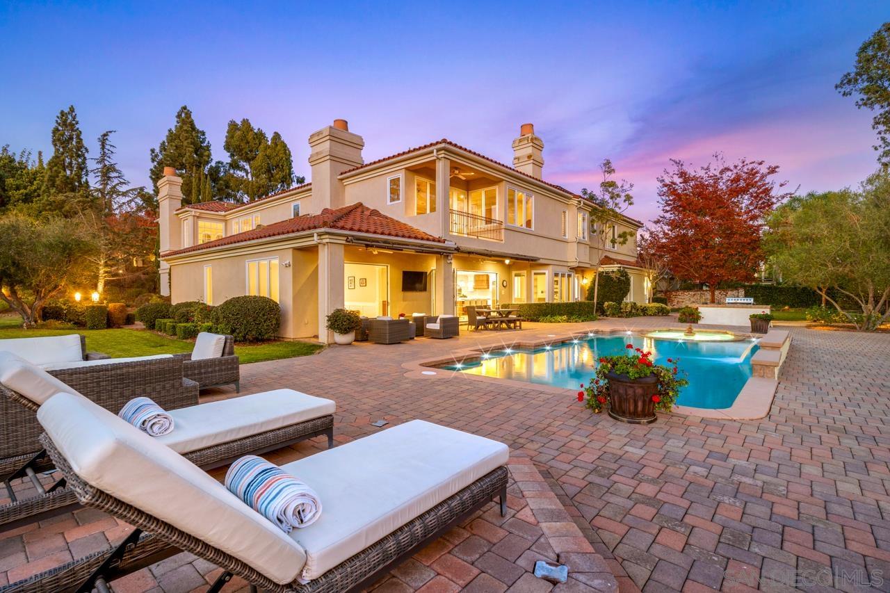 a view of a house with swimming pool and sitting area