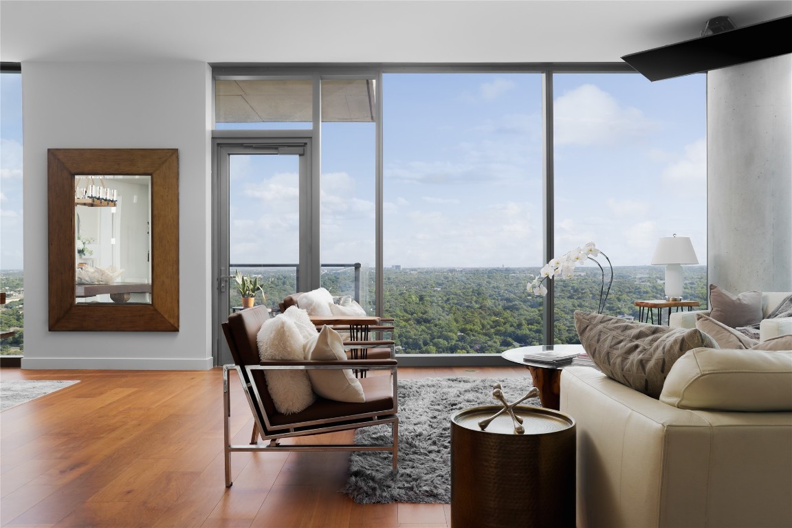 a living room with furniture and a floor to ceiling window