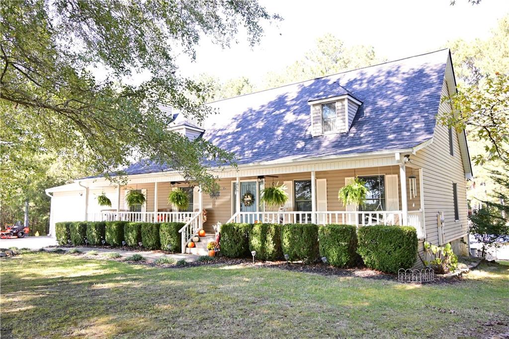 a front view of a house with a yard and potted plants