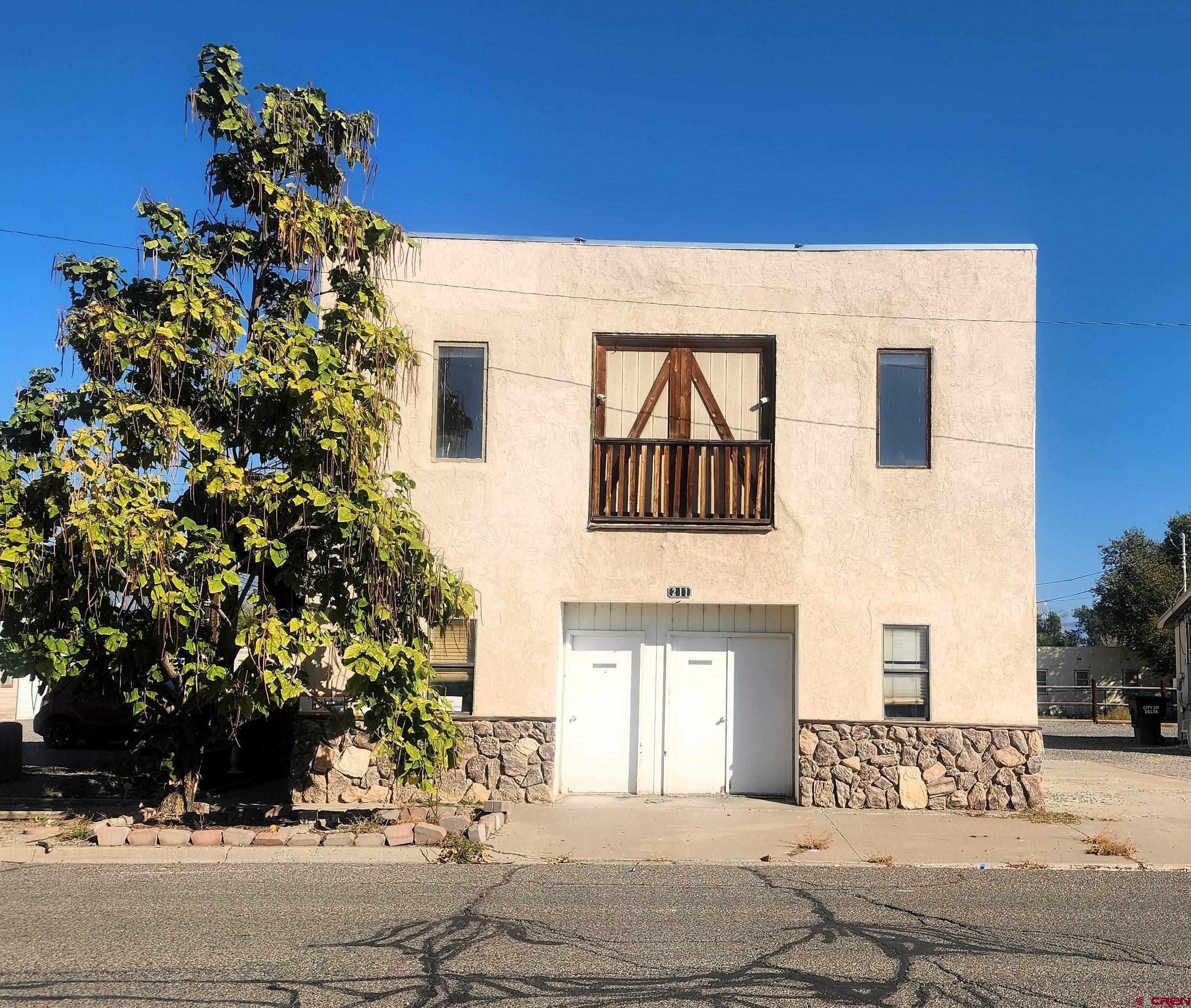 a view of a house with a tree