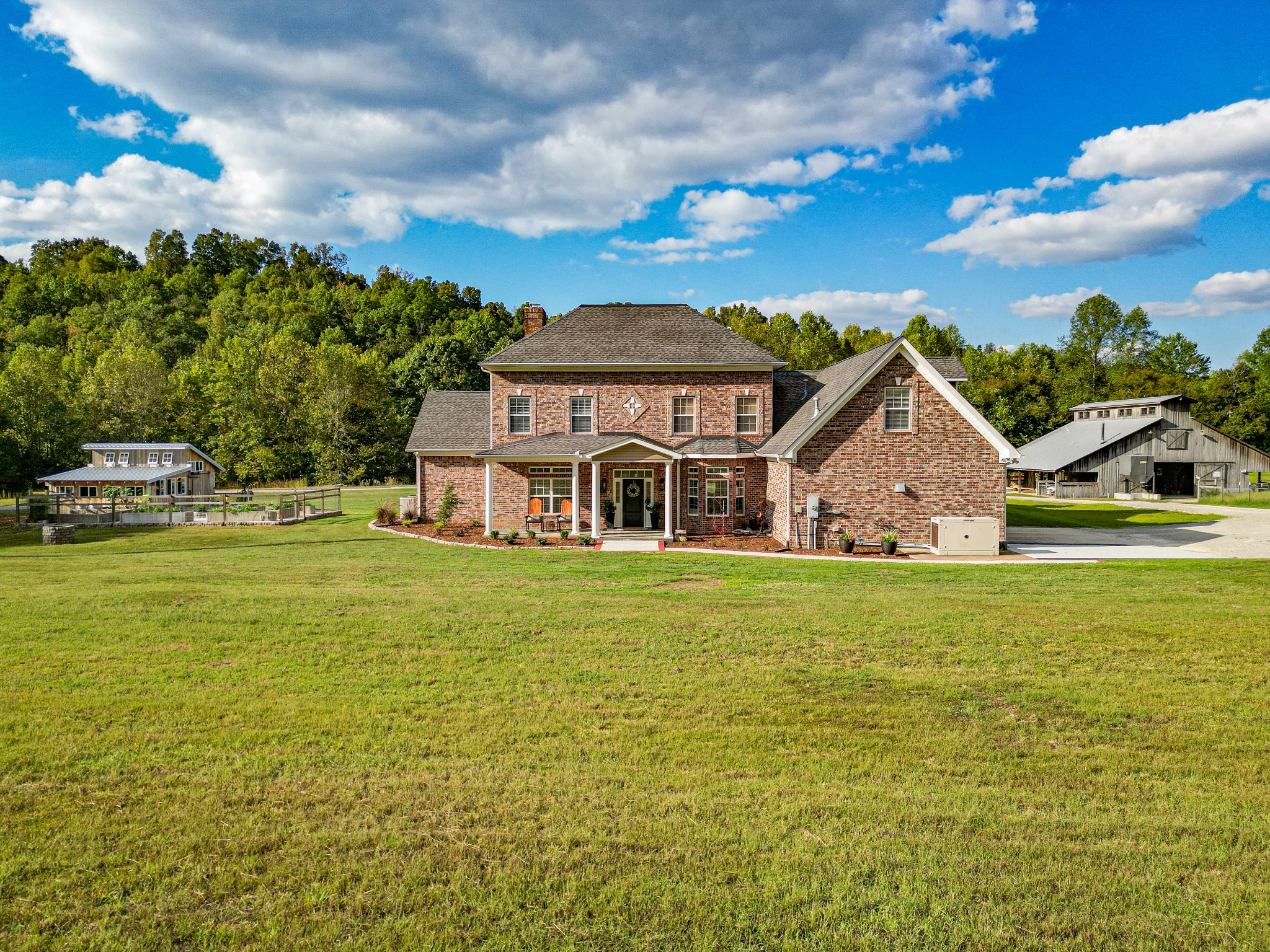 a front view of house with yard and ocean