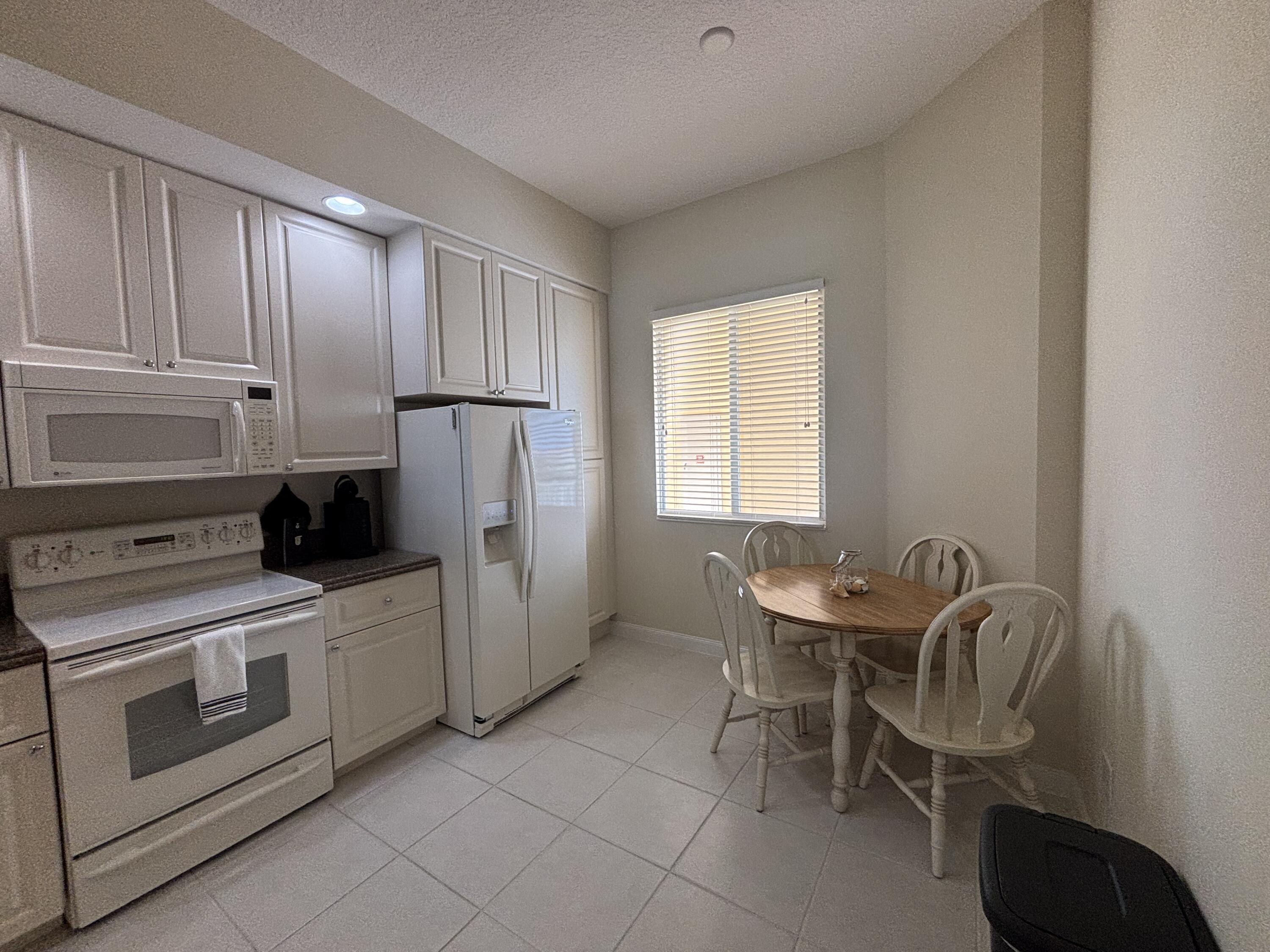 a kitchen with stainless steel appliances a stove a sink and a refrigerator