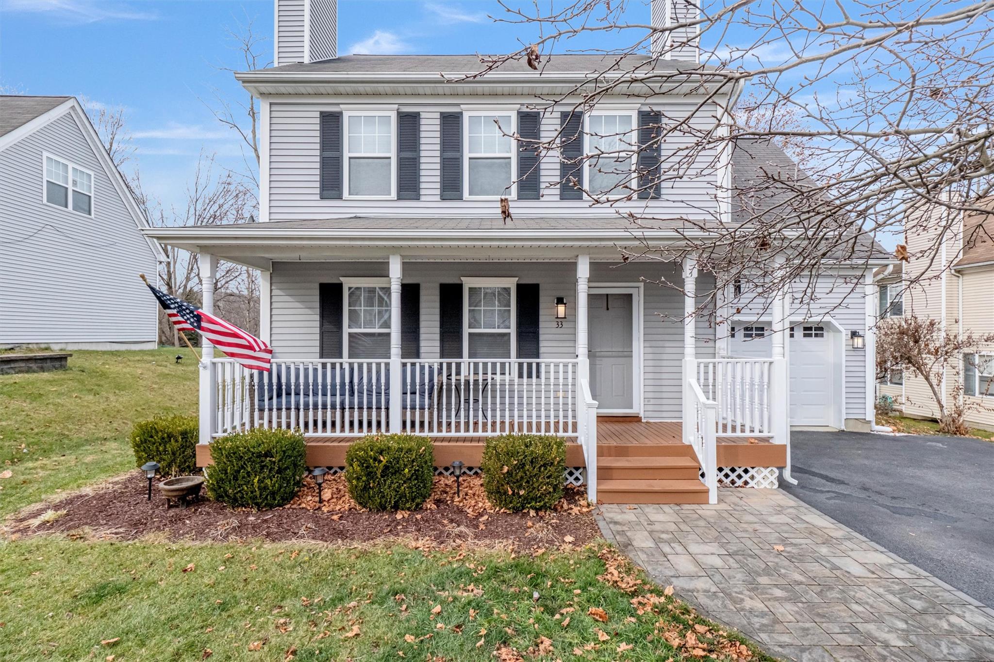 View of front of property with a garage and a front yard