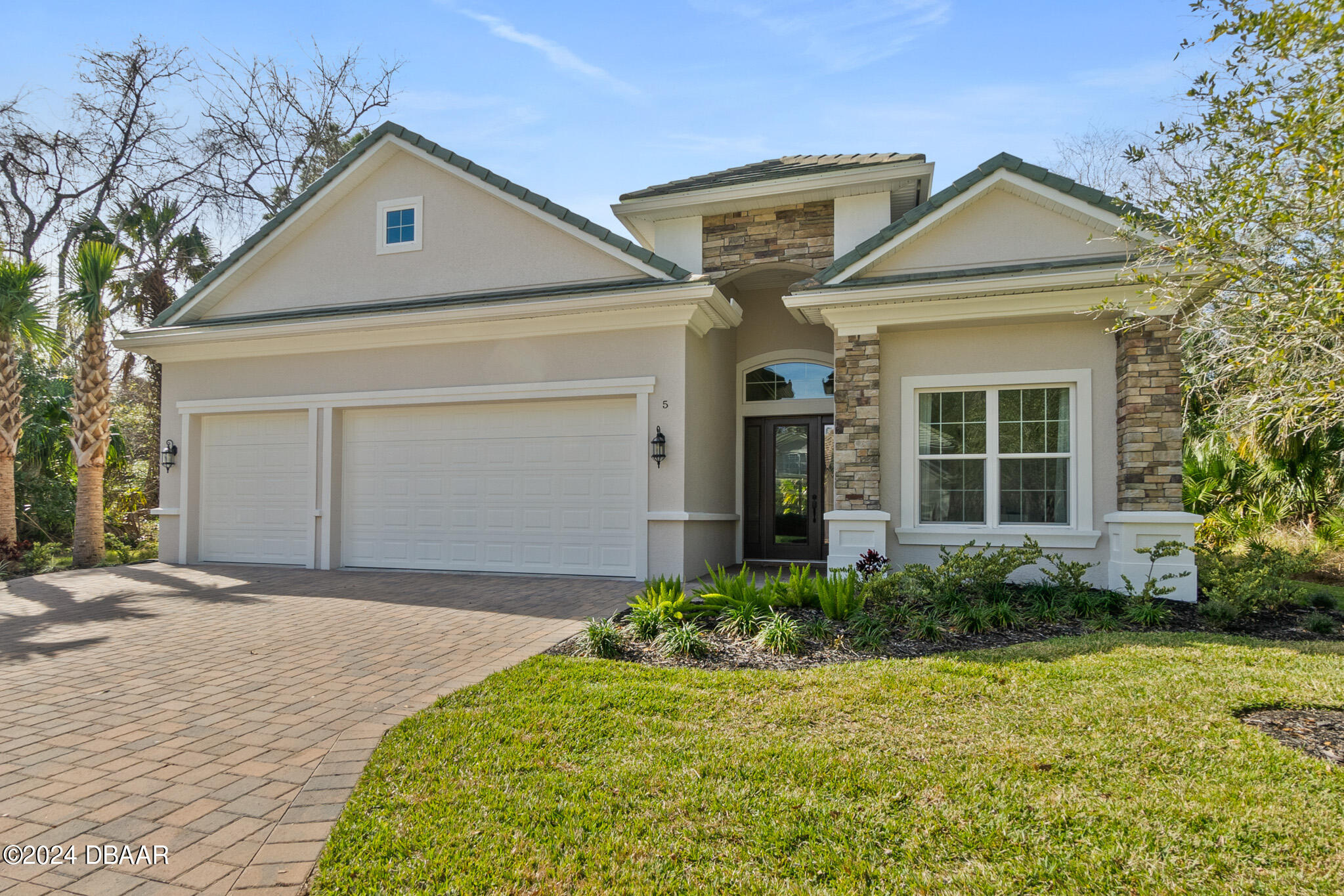 a front view of a house with garden