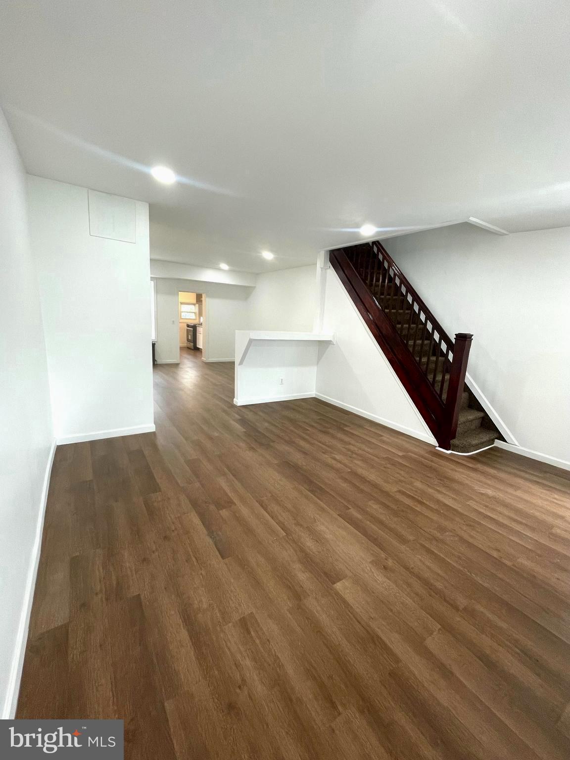 a view of a room with wooden floor and staircase